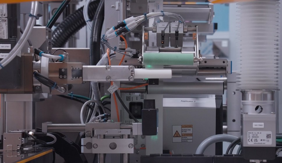 Close-up of the transport and rotation unit on the HERMA 211R HC robotic labeling cell